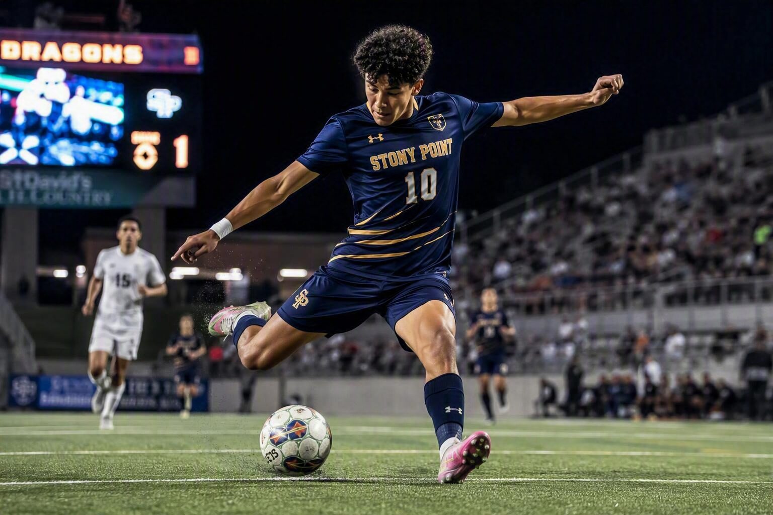 Soccer player captured mid-action kicking the ball during a night game
